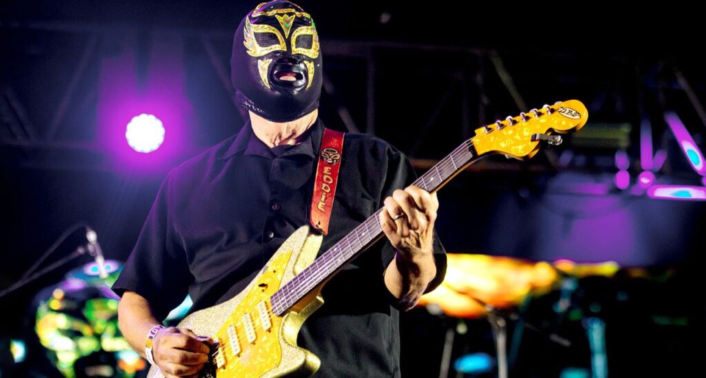“I’m known for these real dumb rock ’n’ roll solos… We don’t think of ourselves as super-pickers”: Primitive solos, Luchador masks, SpongeBob SquarePants? Meet Los Straitjackets, guitar’s most out-there instrumentalists