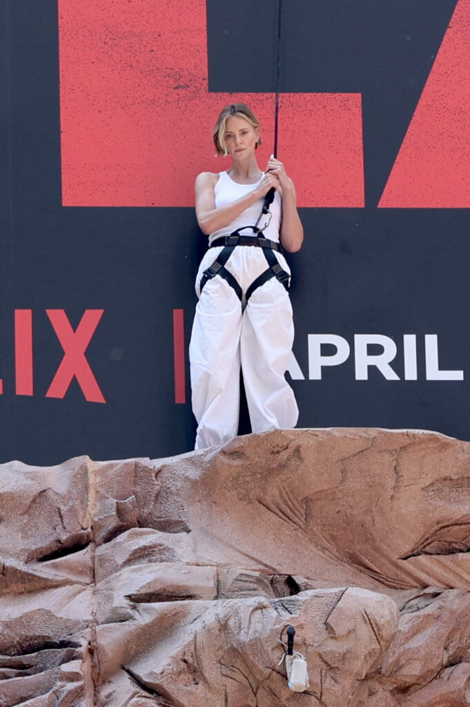 Charlize Theron takes ‘Apex’ promo to new heights with wall-climbing stunt in NYC